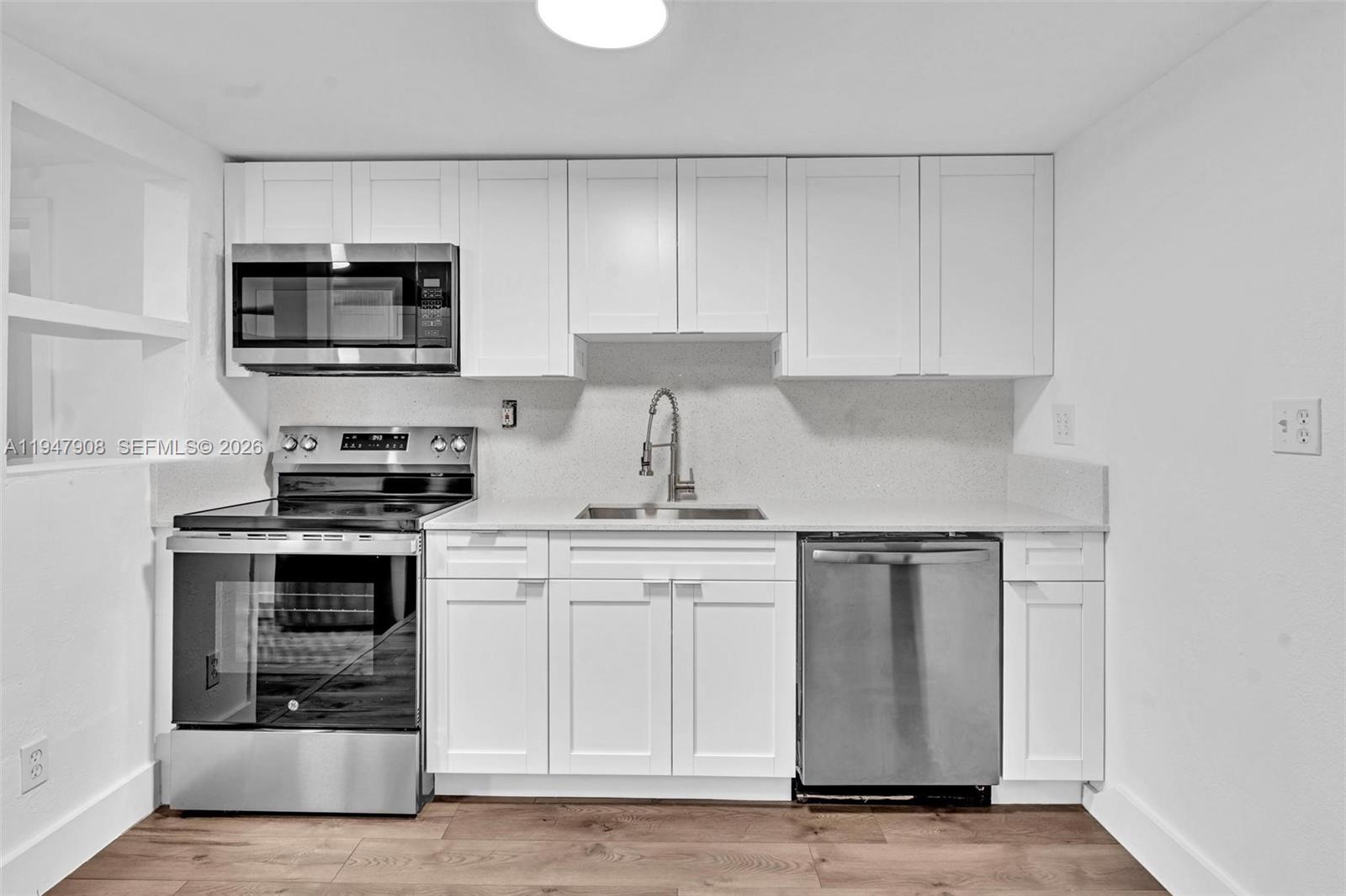 2636 Southwest 29th Court Miami, FL 33133 - Photo 14 of 33 a kitchen with stainless steel appliances granite countertop a stove and a microwave