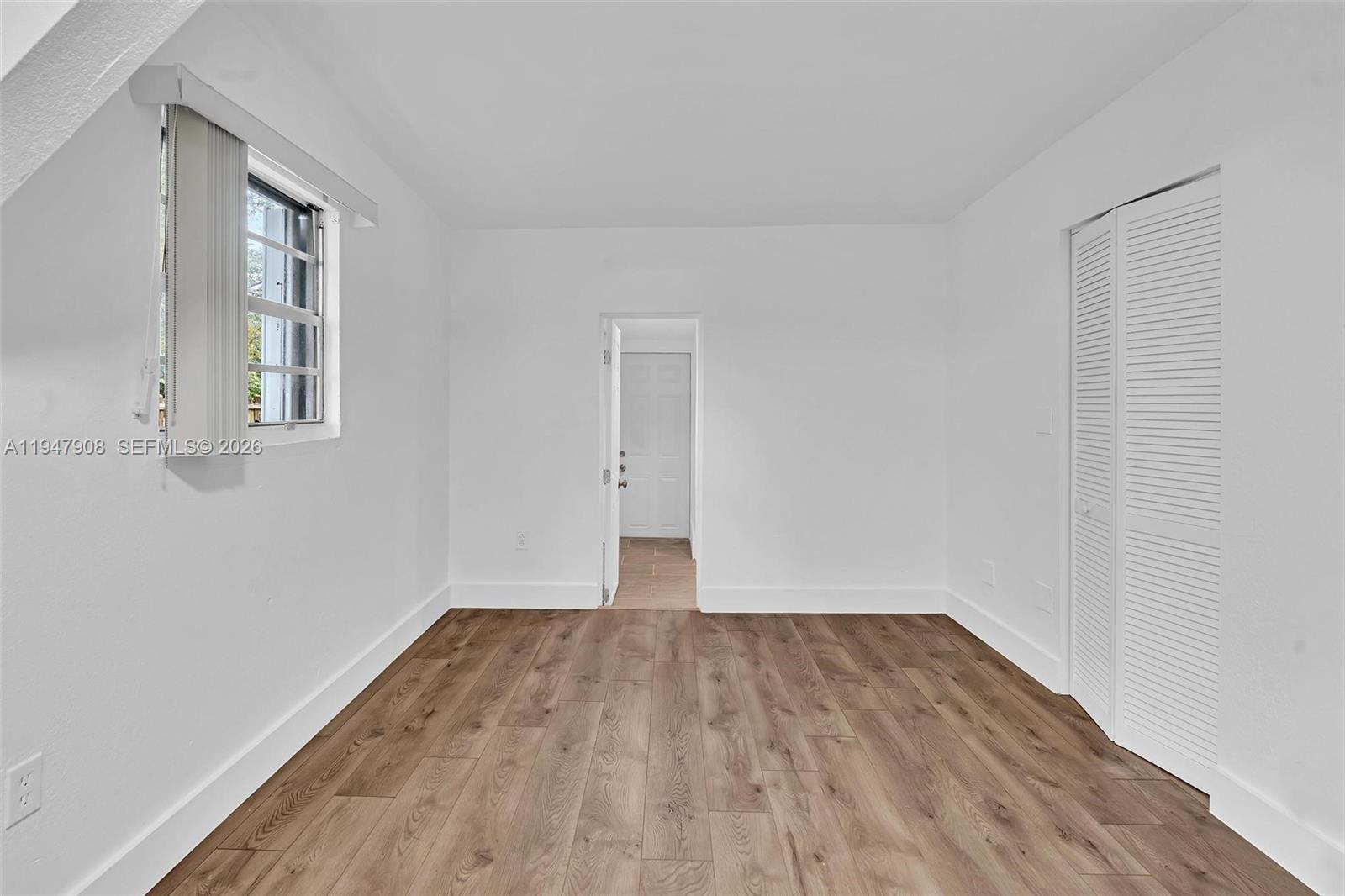 2636 Southwest 29th Court Miami, FL 33133 - Photo 28 of 33 an empty room with wooden floor and windows
