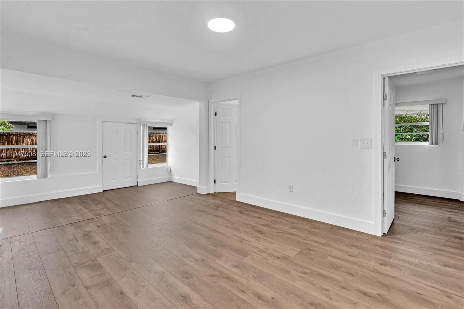 2636 Southwest 29th Court Miami, FL 33133 - Photo 10 of 33 an empty room with wooden floor and windows