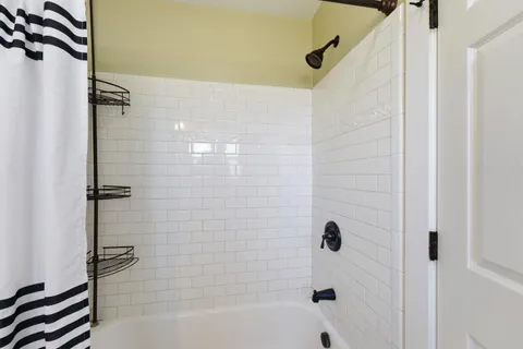 a bathroom with a bathtub and a shower
