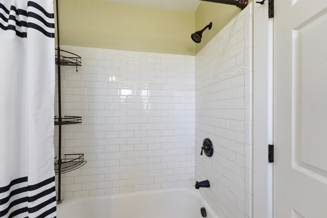 a bathroom with a bathtub and a shower