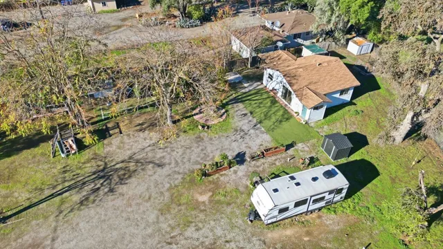 an aerial view of a house with a yard and lake view