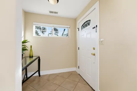 a view of an entryway with wooden floor