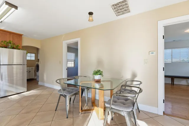 a view of a dining room with furniture and a chandelier