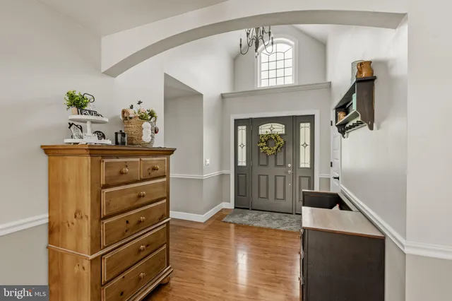 a living room with fireplace furniture and a wooden floor