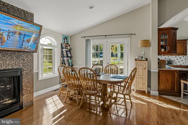 a living room with furniture a fireplace and a painting