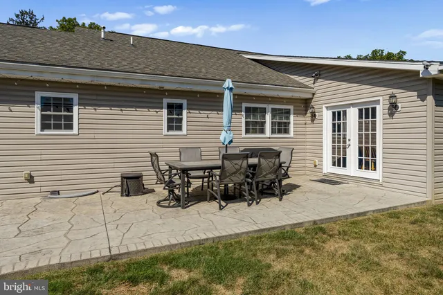 a view of a swimming pool with a patio and a yard