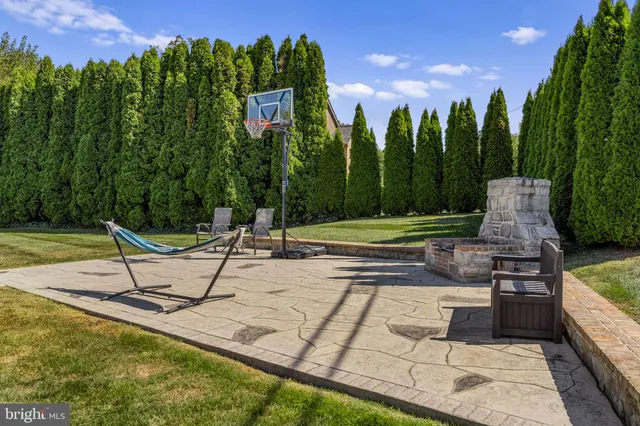 a view of a patio with table and chairs under an umbrella