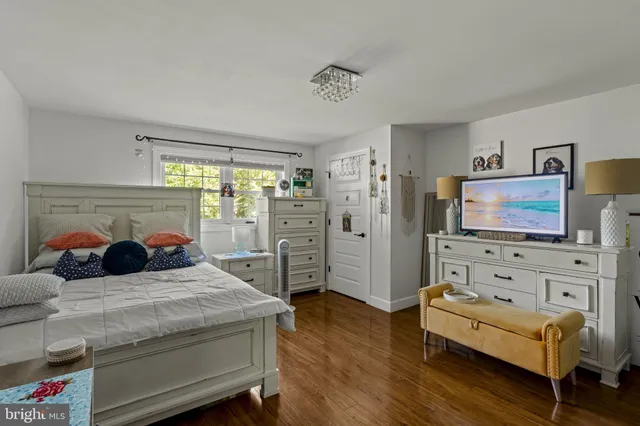 a bedroom with two beds and a dresser