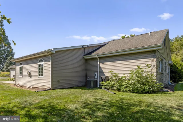 an aerial view of a house with a garden and lake view