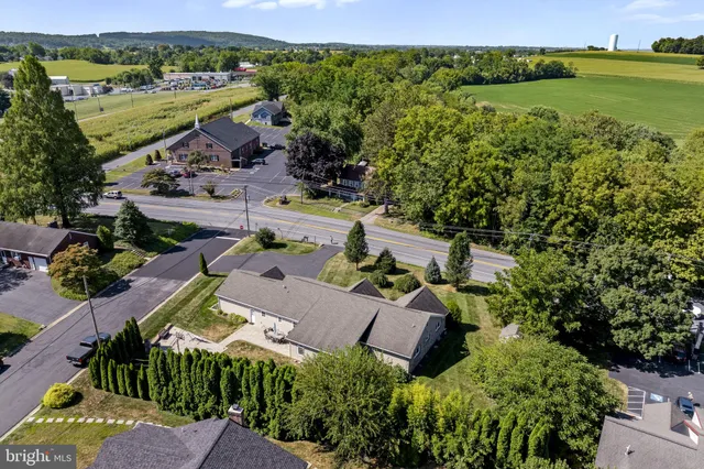 a view of a house with a yard and sitting area