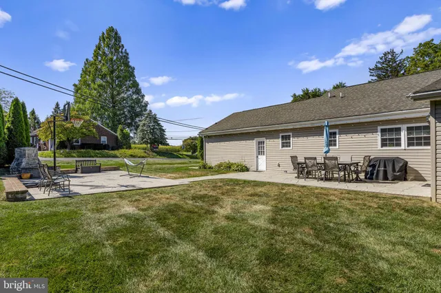 an aerial view of a house with swimming pool garden and patio