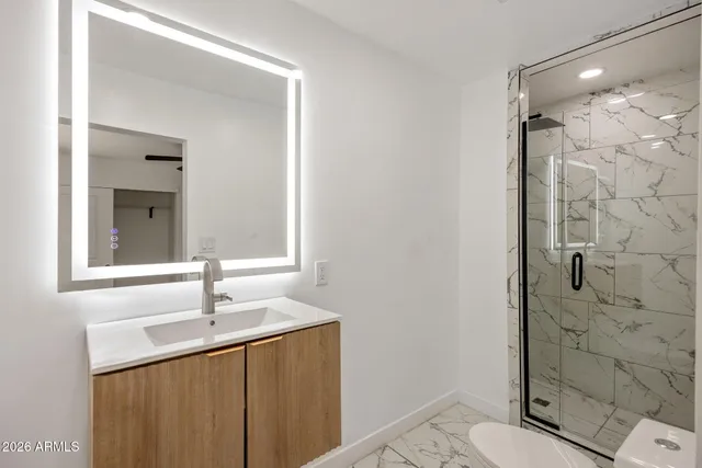 a bathroom with a sink toilet and shower