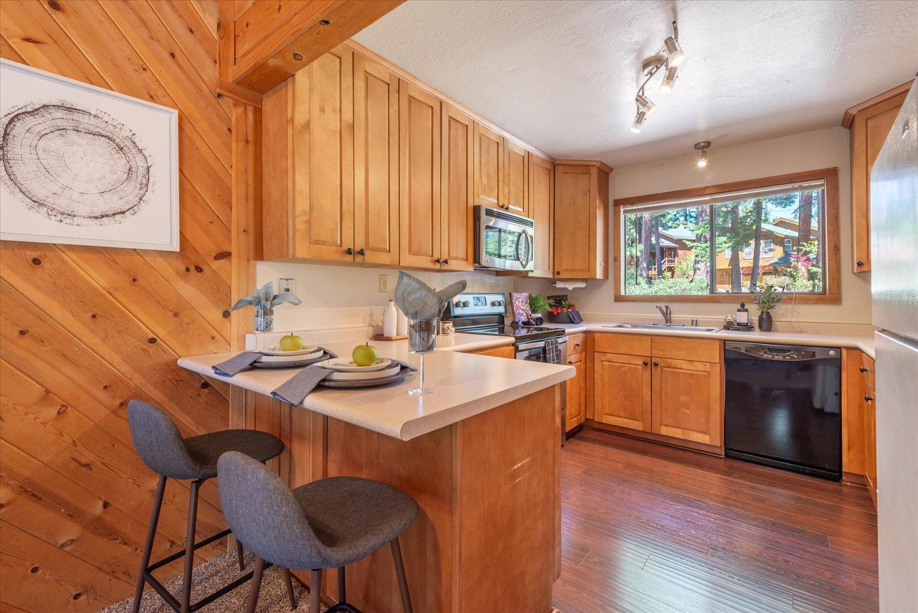 325 North Ridge Road Carnelian Bay, CA 96140 - Photo 14 of 22 a kitchen with a sink cabinets a counter top space and stainless steel appliances