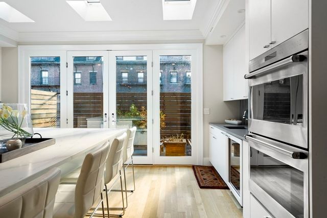 a kitchen with stainless steel appliances granite countertop a stove and a refrigerator