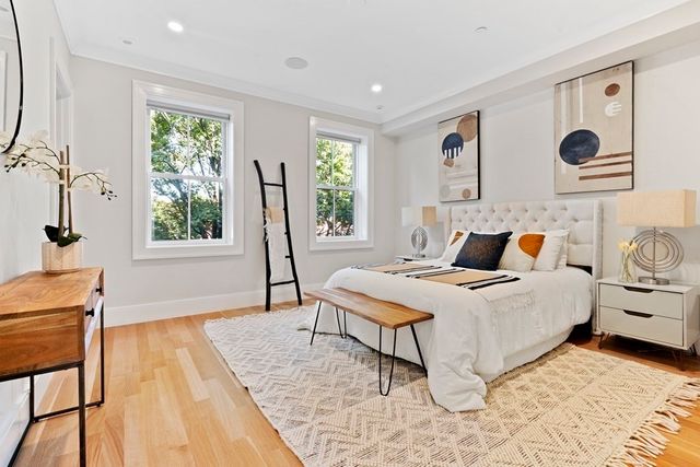 a bed room with a bed and a chair