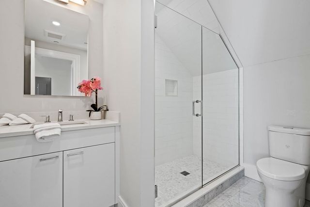 a bathroom with a sink toilet and shower