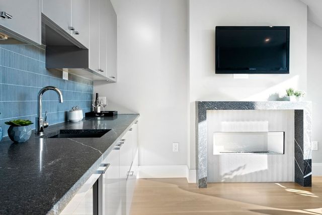 a kitchen with a sink a counter and cabinets