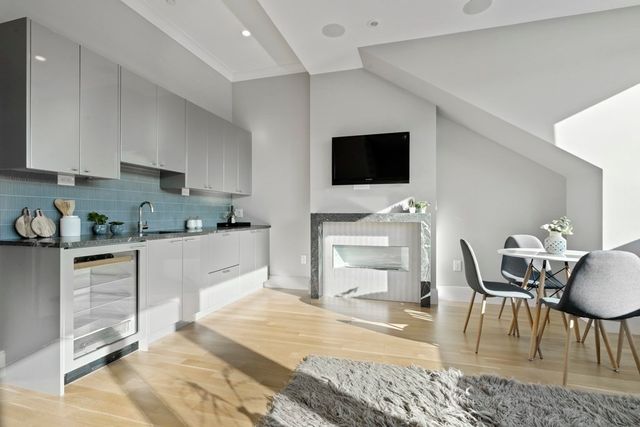 a kitchen with stainless steel appliances kitchen island granite countertop a stove a sink and a microwave