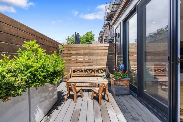 a picture of a glass door with sitting area