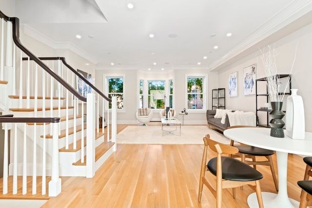 a view of a dining room and hall with wooden floor