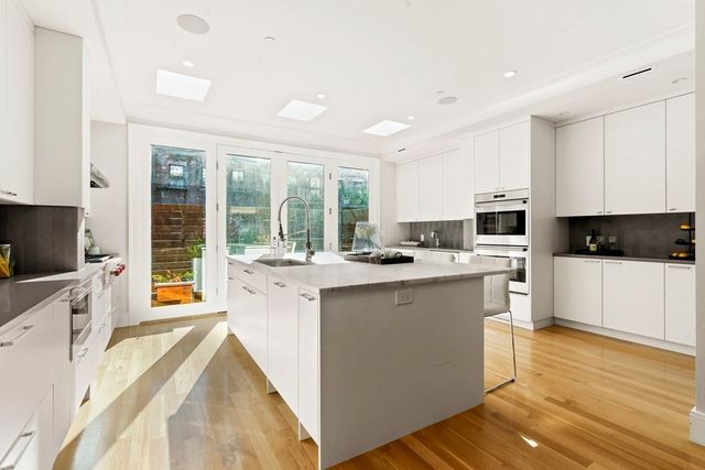 a kitchen with counter top space cabinets and appliances