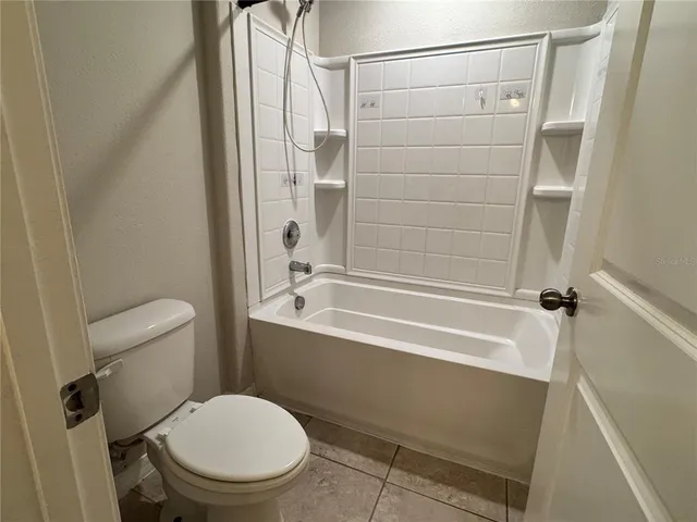 a bathroom with a toilet and a bathtub