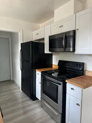 a kitchen with stainless steel appliances a stove a microwave and cabinets