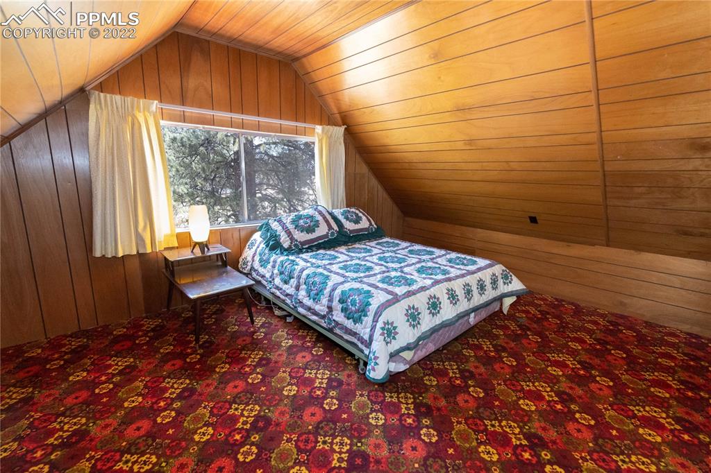 442 Due S Road Florissant, CO 80816 - Photo 12 of 43 a bedroom with a bed and wooden floor