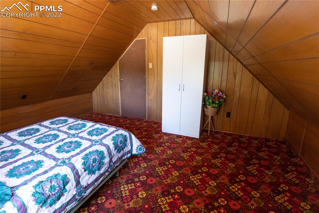 442 Due S Road Florissant, CO 80816 - Photo 13 of 43 a bedroom with a bed and a wooden fence