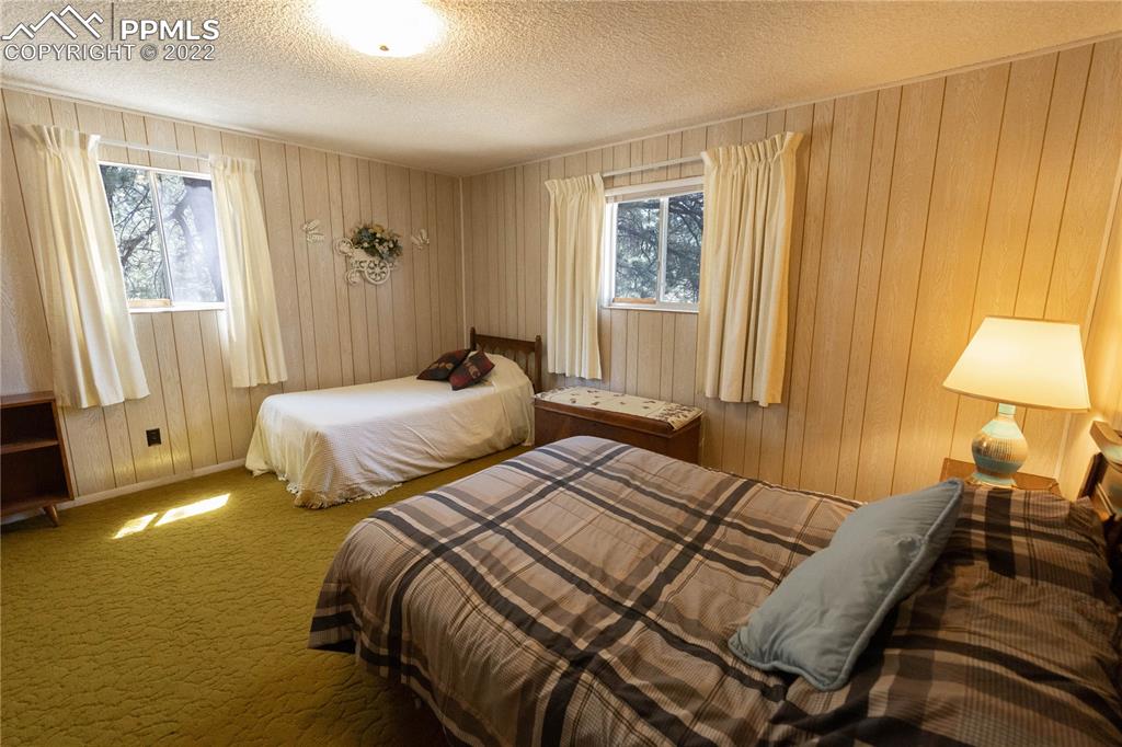 442 Due S Road Florissant, CO 80816 - Photo 14 of 43 a bedroom with two beds and a lamp