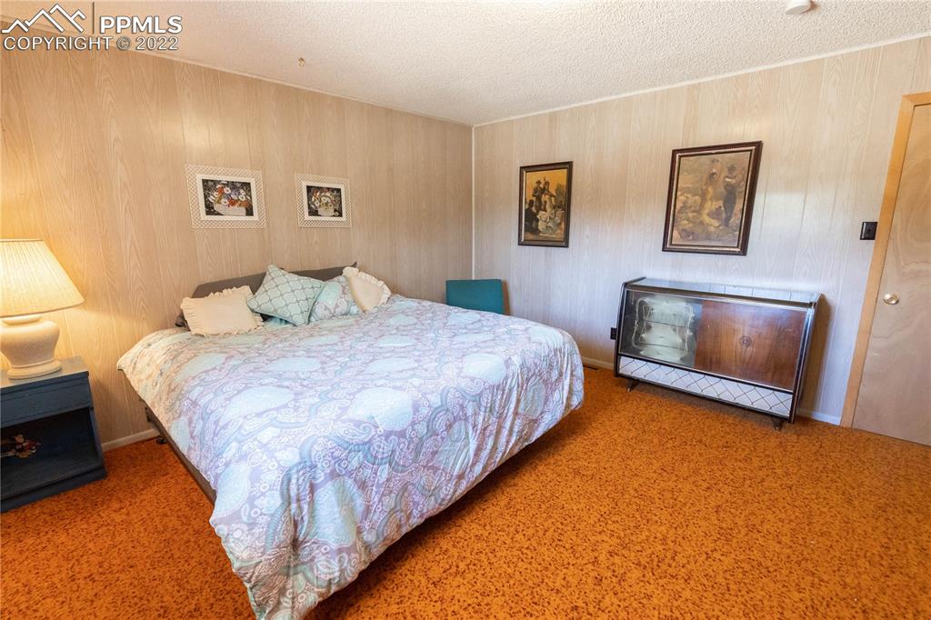 442 Due S Road Florissant, CO 80816 - Photo 19 of 43 a bedroom with a bed and night stand