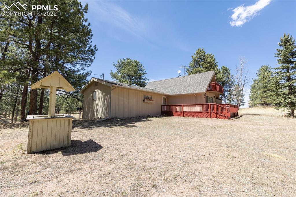 442 Due S Road Florissant, CO 80816 - Photo 6 of 43 a backyard of a house with table and chairs with wooden fence
