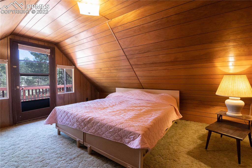 442 Due S Road Florissant, CO 80816 - Photo 9 of 43 a bedroom with a bed a chair and lamp