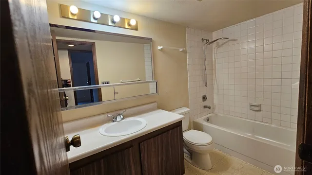 a view of a door of the house with a flower garden