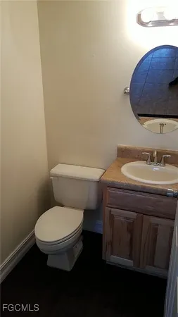 a white toilet sitting next to a bathroom sink