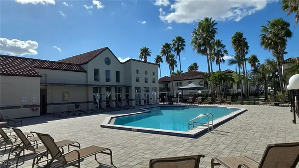 a front view of a house with swimming pool having outdoor seating