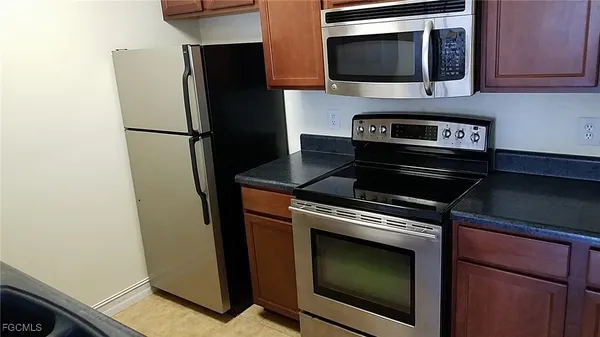 a kitchen with stainless steel appliances wooden cabinets and a stove top oven