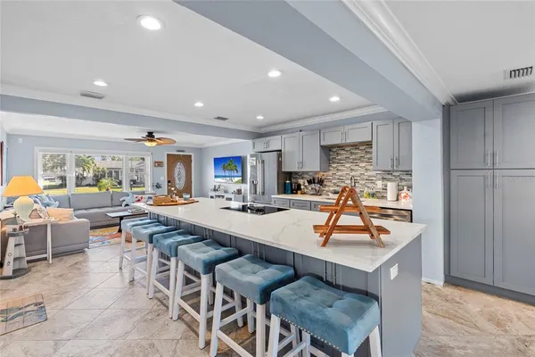 a kitchen with a dining table chairs and view kitchen