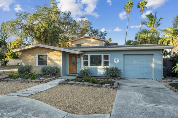 front view of house with potted plants