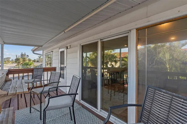 a view of a house with swimming pool and sitting area
