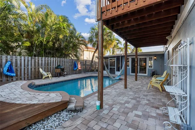 a view of a patio with couches chairs dining table and chairs with wooden floor