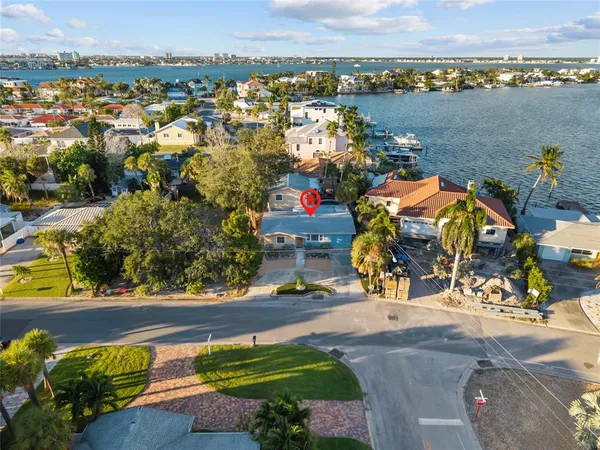 an aerial view of lake and residential houses with outdoor space