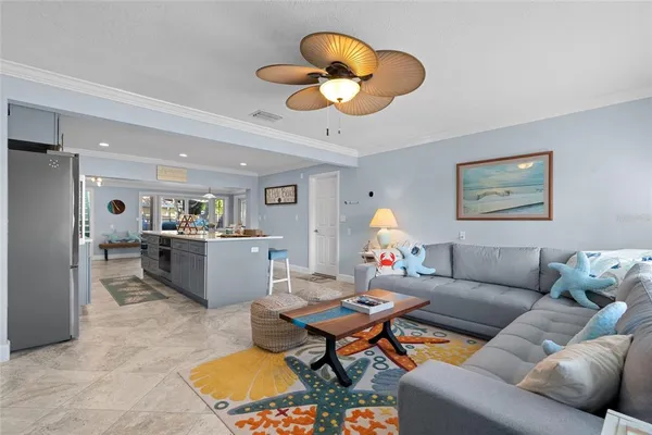 a living room with furniture a rug and a chandelier