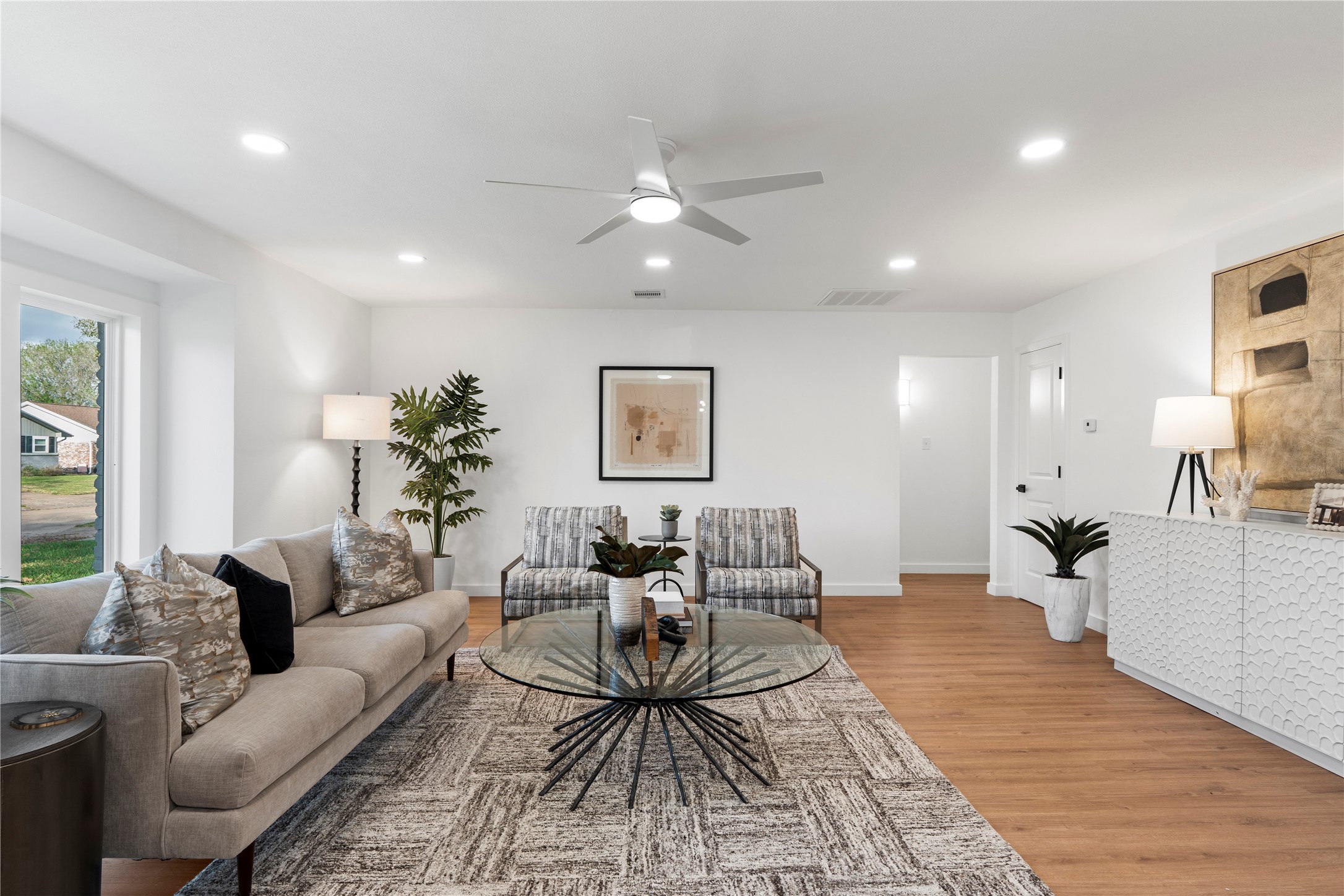 5023 Redstart Street Houston, TX 77035 - Photo 5 of 34 Deep-set windows and high ceilings with recessed lighting create a sense of grandeur and volume throughout the main living space.