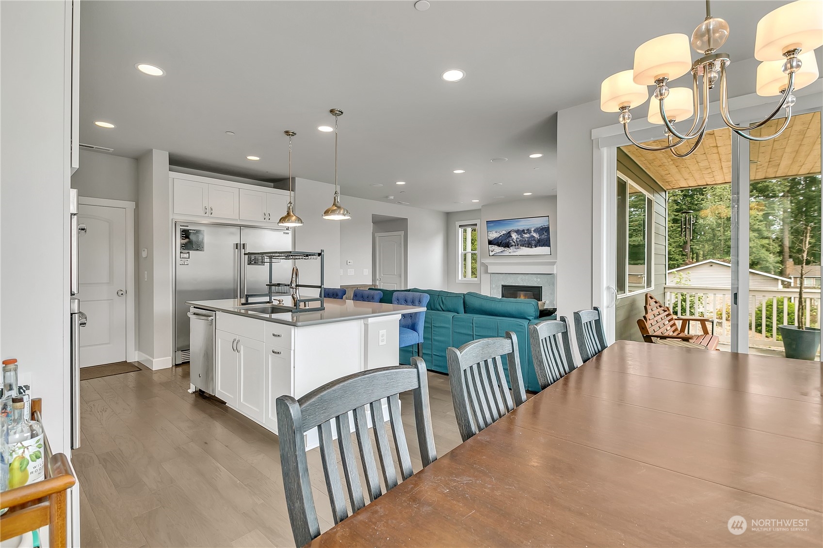 18103 Baldwin Road Bothell, WA 98012 - Photo 13 of 39 a large white kitchen with lots of counter space dining table and stainless steel appliances
