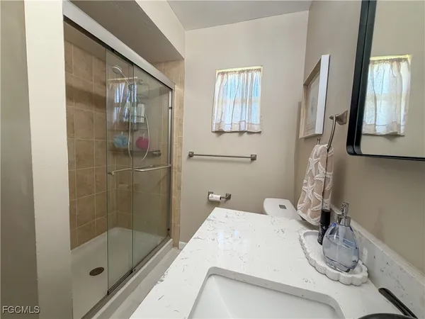 a bathroom with a bathtub sink vanity and granite
