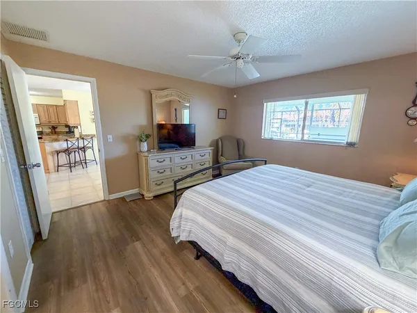 a bedroom with bed and wooden floor