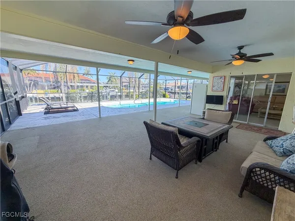 a living room with furniture and a ceiling fan