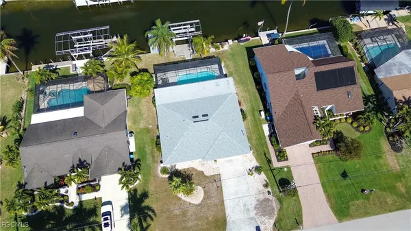 an aerial view of a house with a yard and potted plants